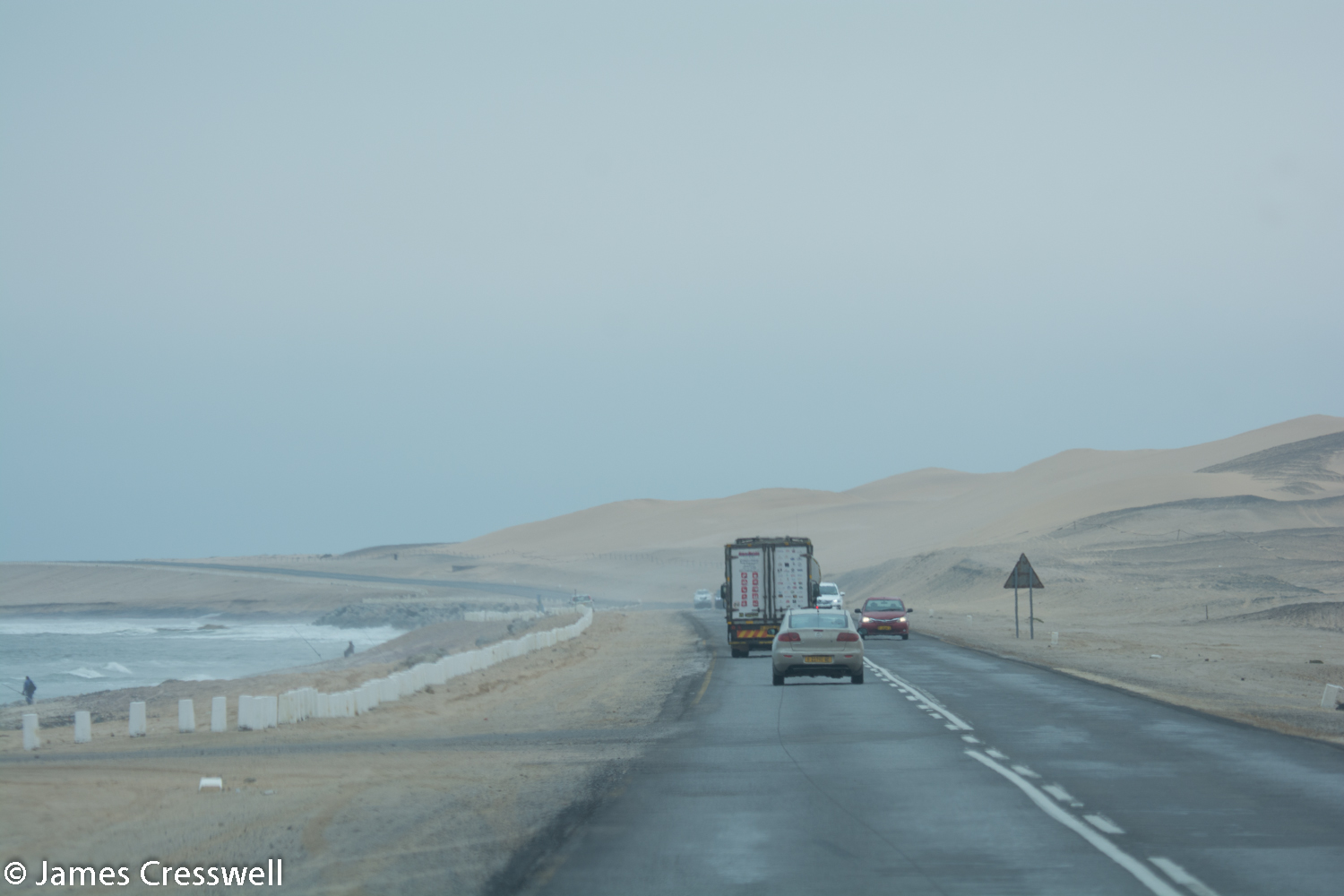 The coast road between Walvis Bay and Swakopmund. Here the desert dunes reach the sea. The area is usually foggy due to the cold temperature of the sea.