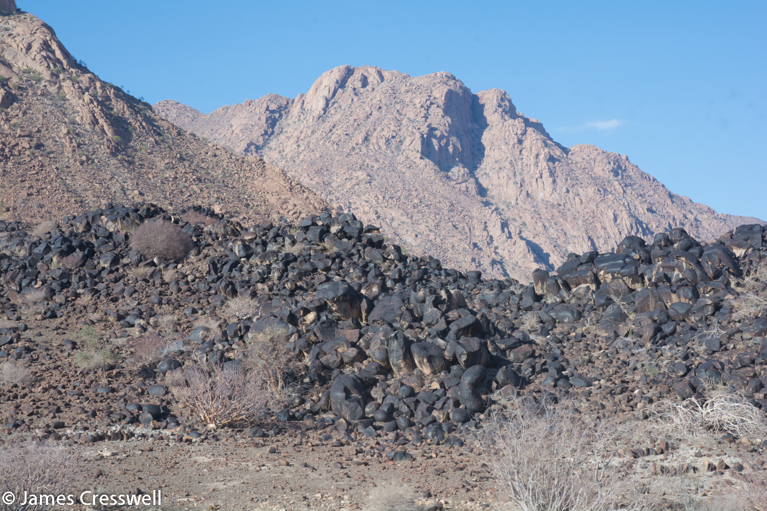 A dolerite dyke coated in desert varnish at the base of the Brandberg, Namibia.