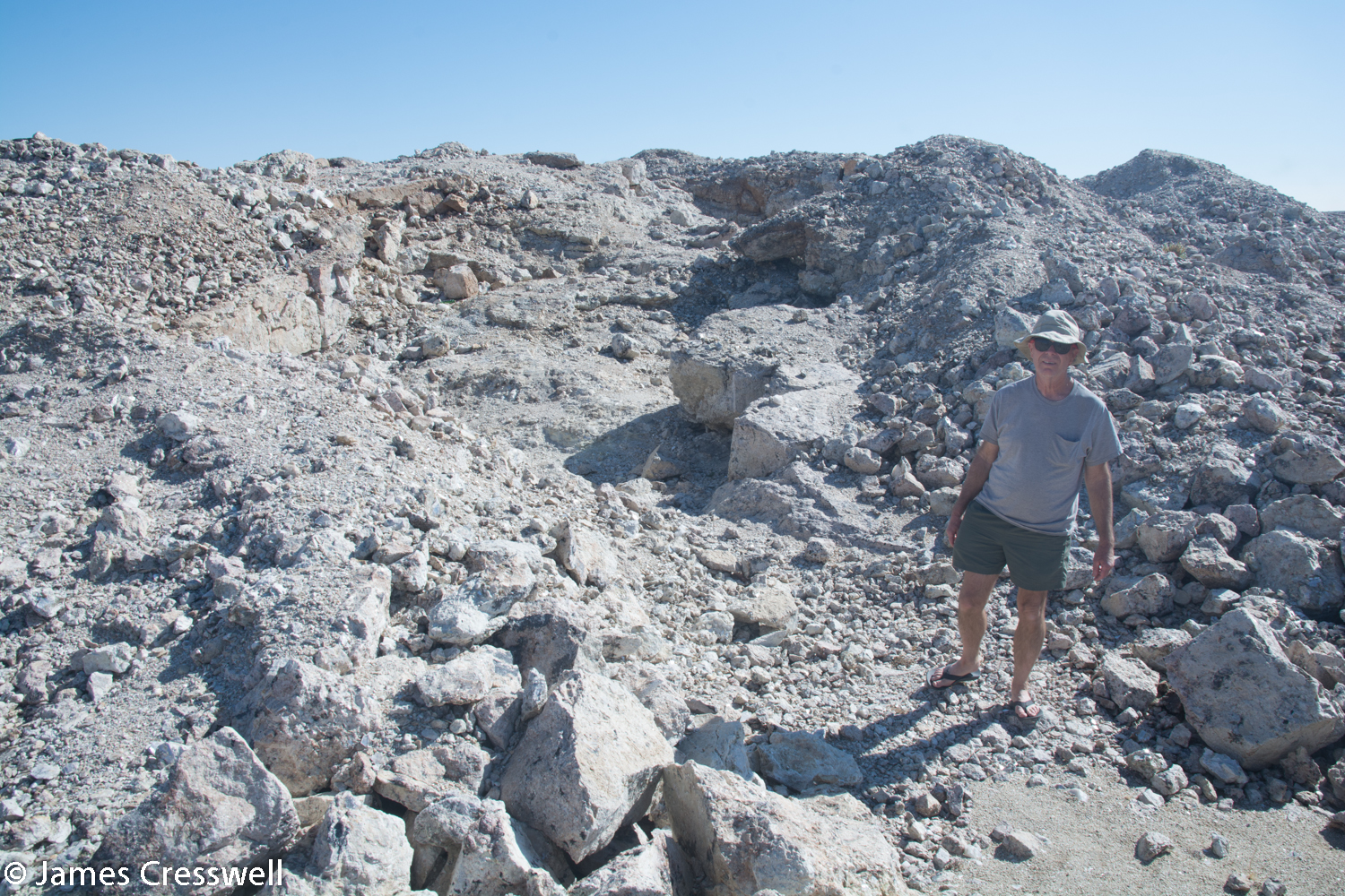 A pit where a pegamatite vein was mined out for its gem-quality green tourmaline crystals. Abundant black tourmaline and mica sheets can still be found here.