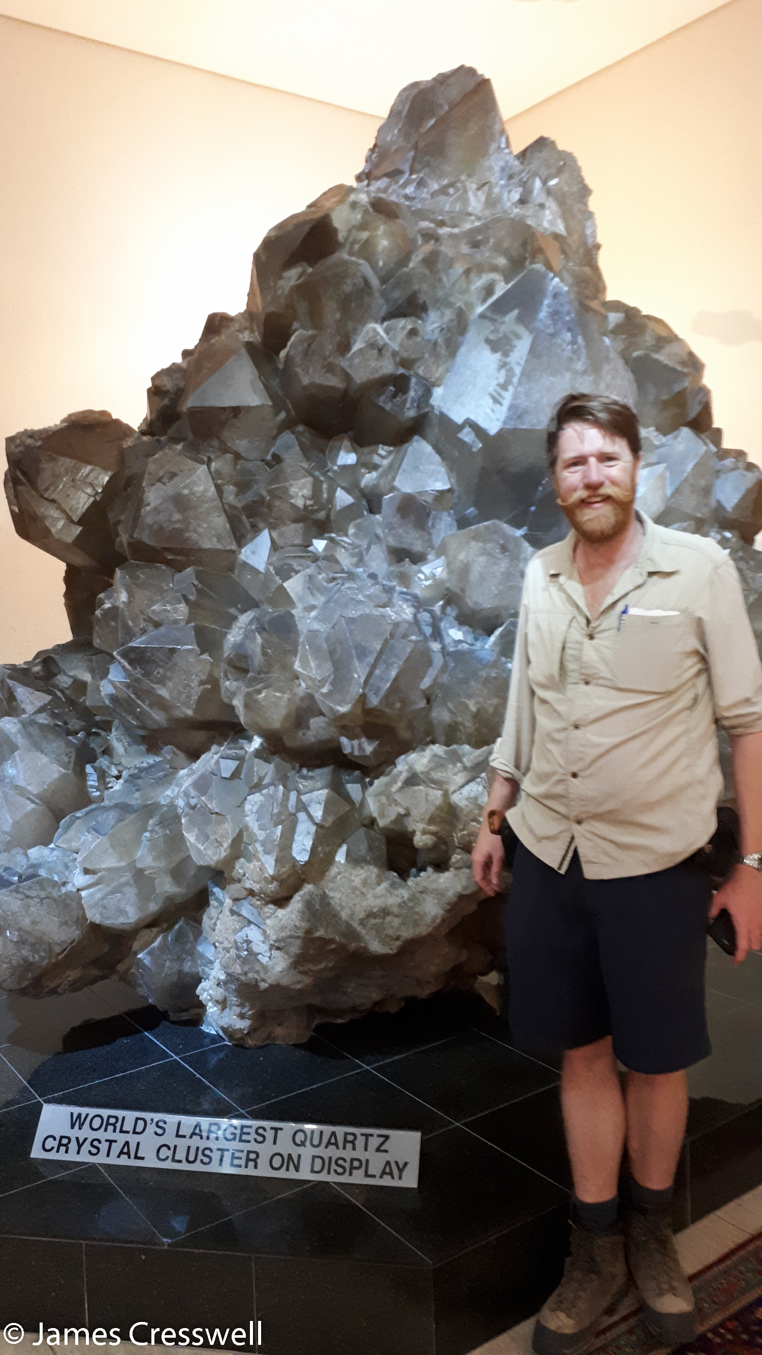 James Cresswell with the world's biggest quartz crystals that are on display, at the Kristall Gallerie, Swakopmund, Namibia.