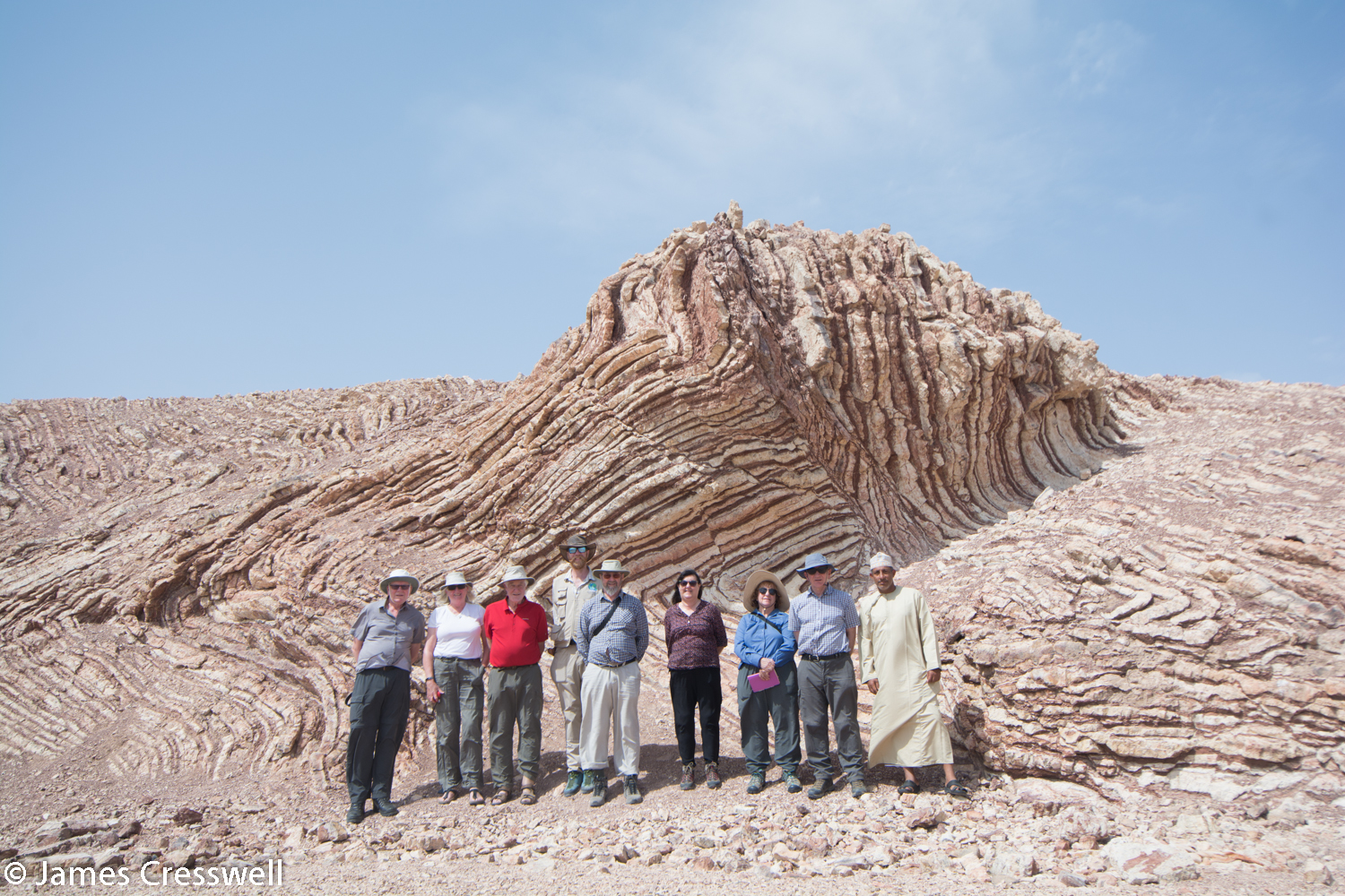 Our GeoWorld Travel group at the "Mother of All Outcrops" - beds of red radiolarian cherts and white porcellanite