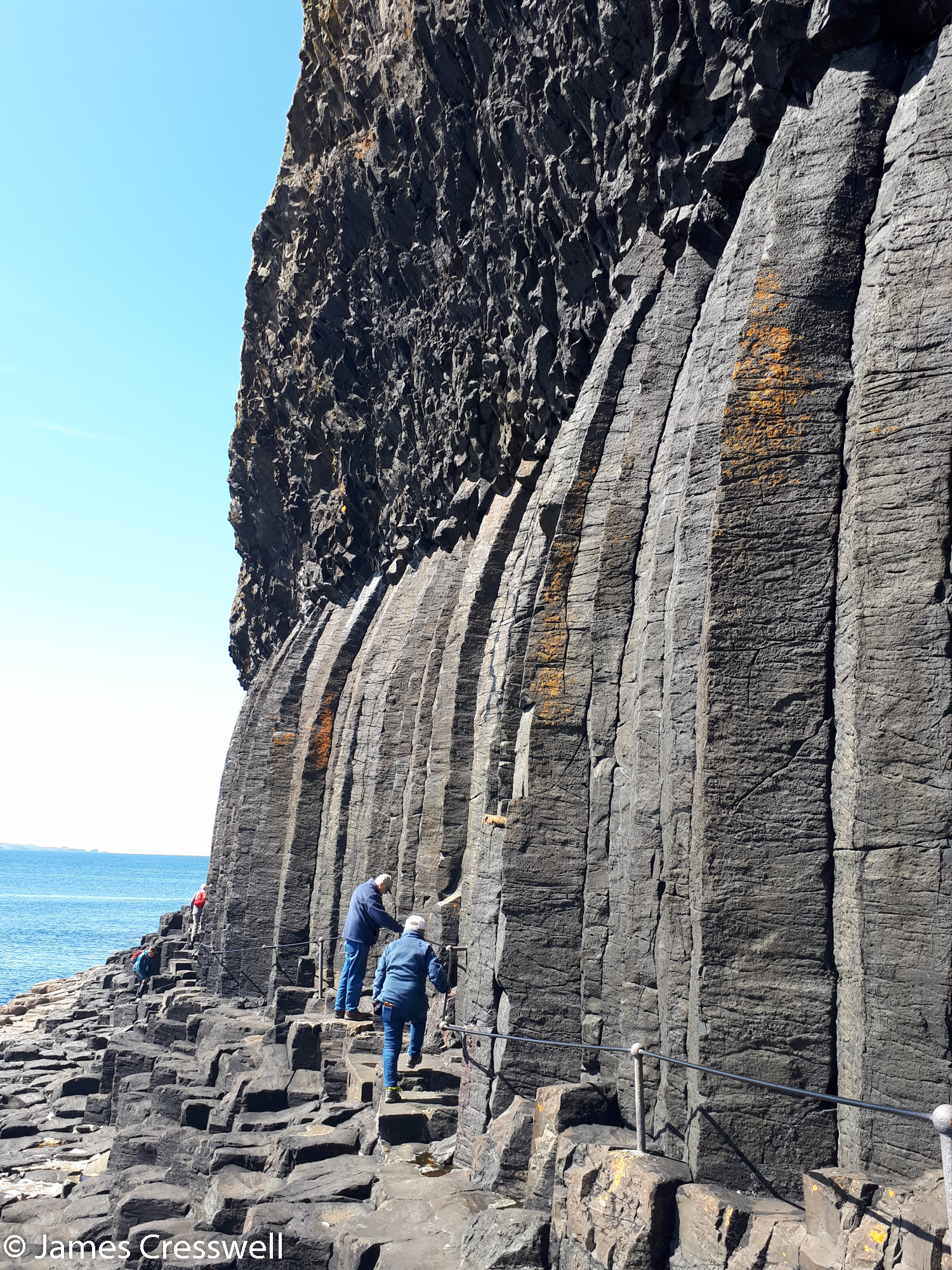 Close-up view of the vertical columnar cooling structures curving inwards with entablature above