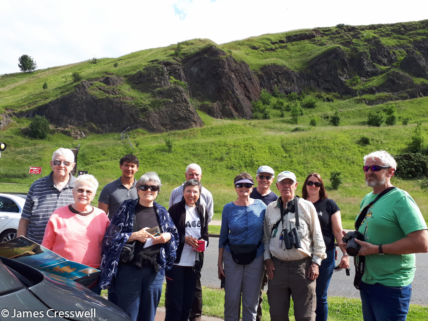 The GeoWorld Travel group in Holyrood Park with the Salisbury Crags sill of the Arthur's Seat volcano in the background