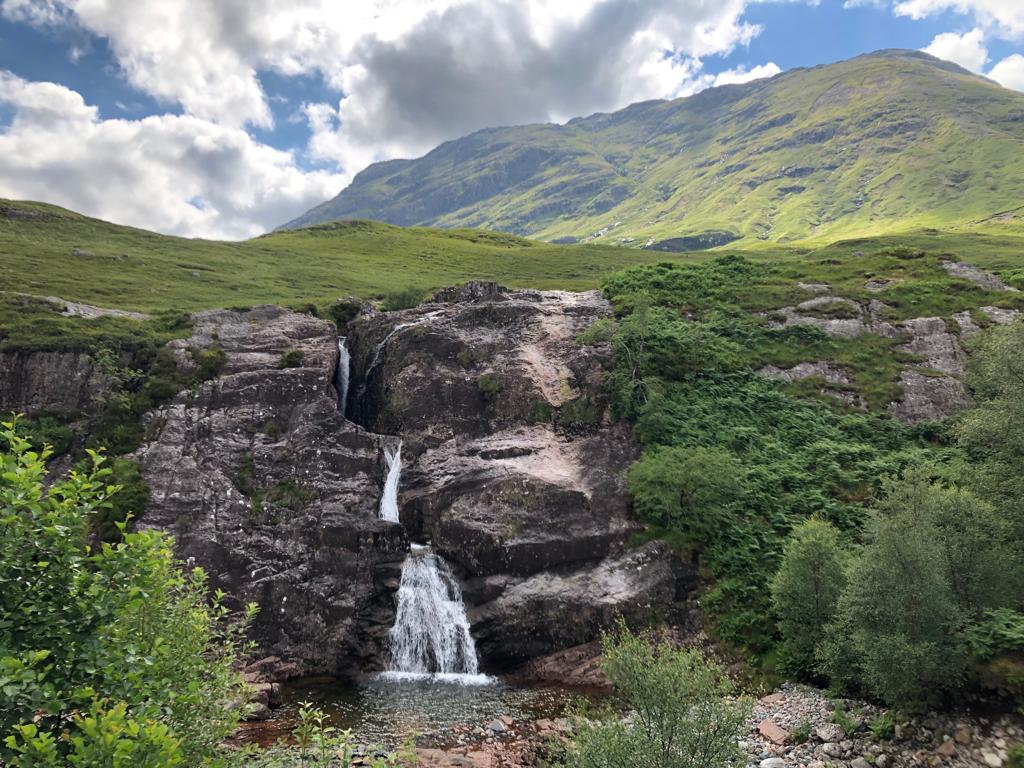 Waterfall flows over a dyke in the Devonian Glencoe volcano