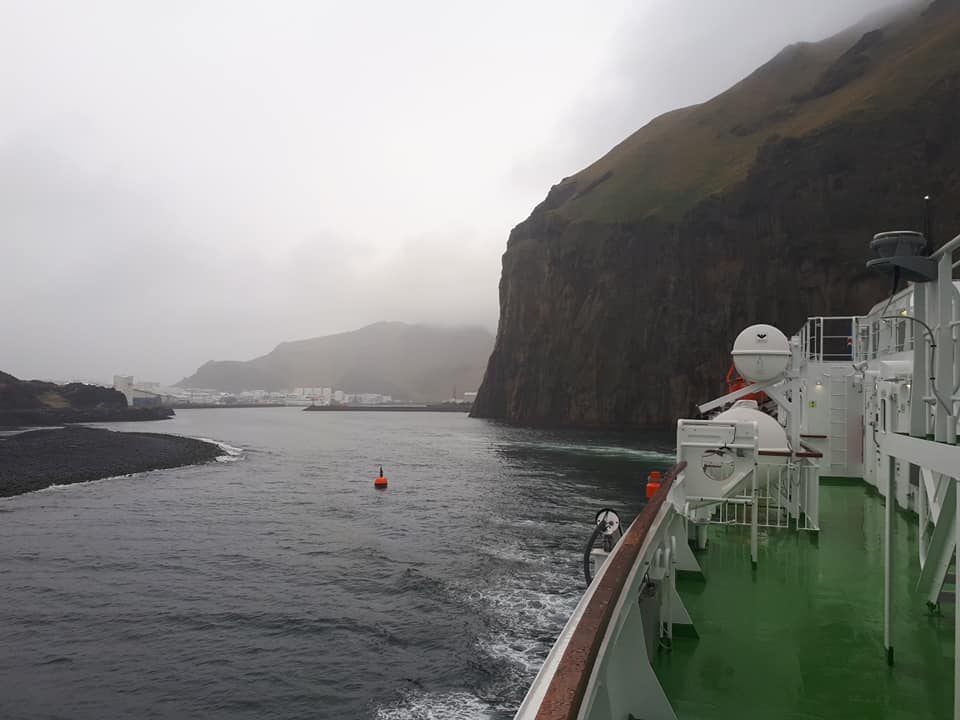 Ferry passing cliffs