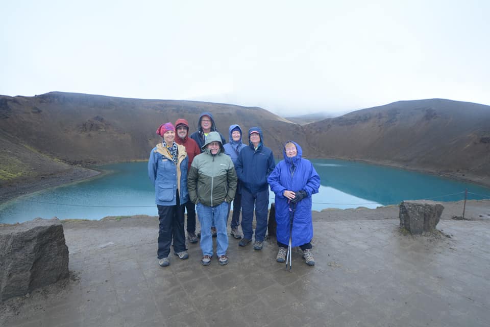 Group next to water-filled volcanic crater