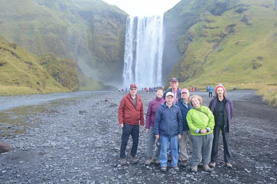 Group of people in front of Skogarfoss waterfall