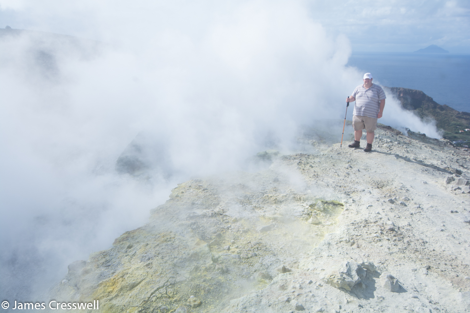 Man on steaming volcanic crater