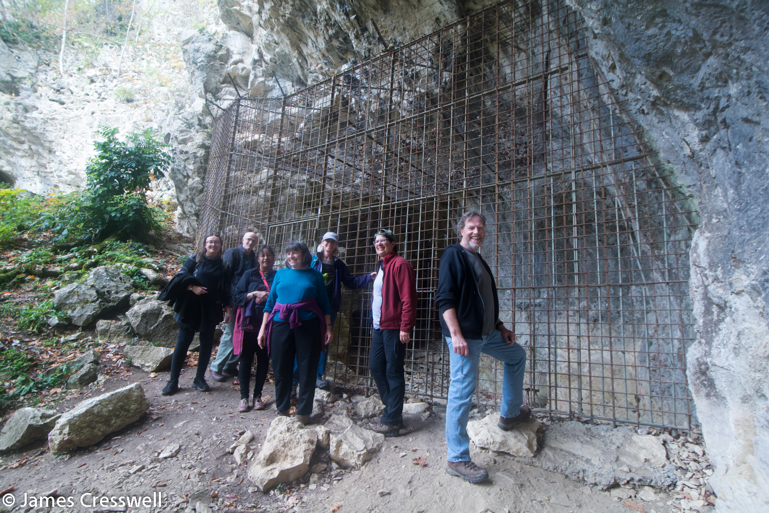 People outside a cave entrance
