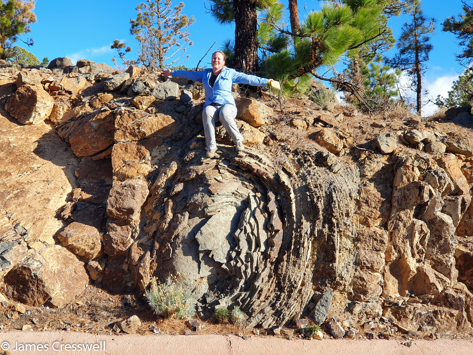 Woman sitting on geological feature