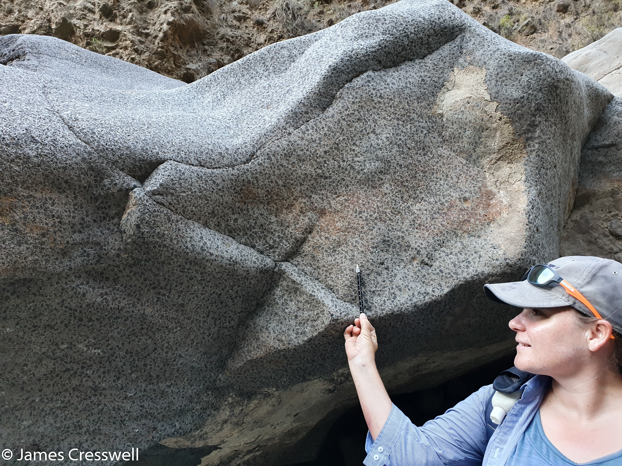 Woman pointing out a geological feature