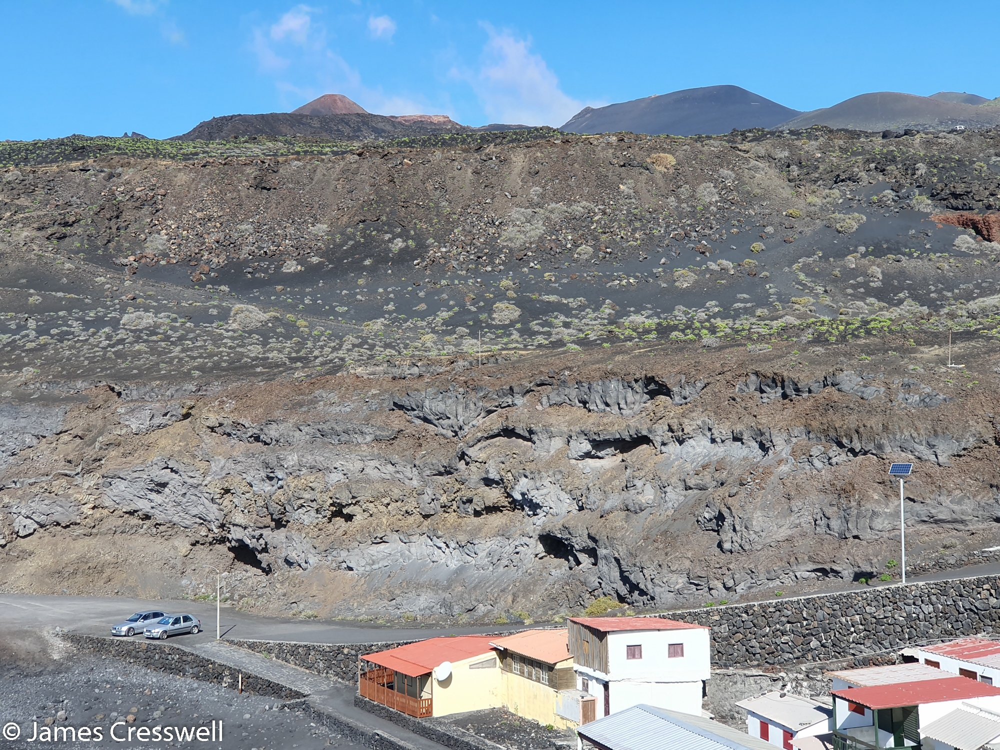 Solidified lava flows behind some houses