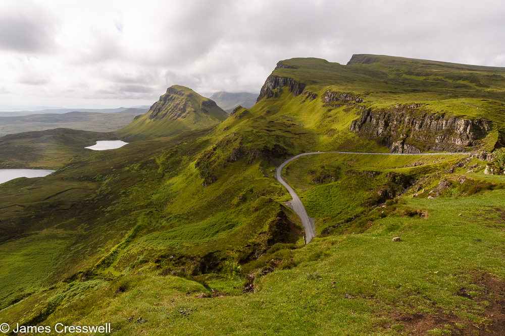 A road winds its way up an inland cliff