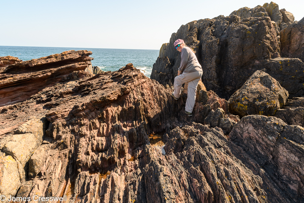 A woman standing on rocks