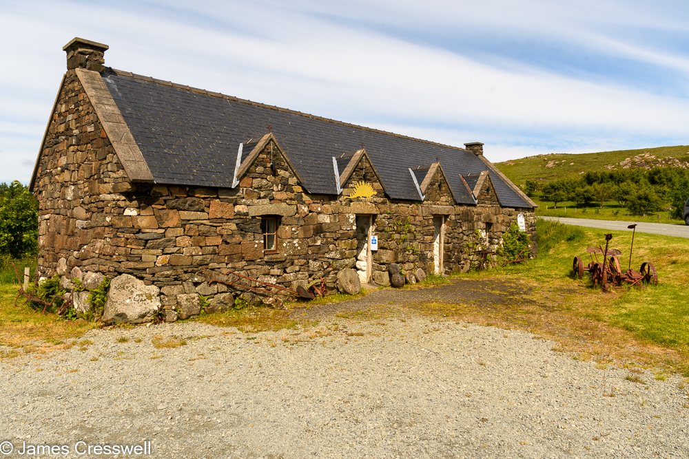 A stone one storey building with a pitched roof