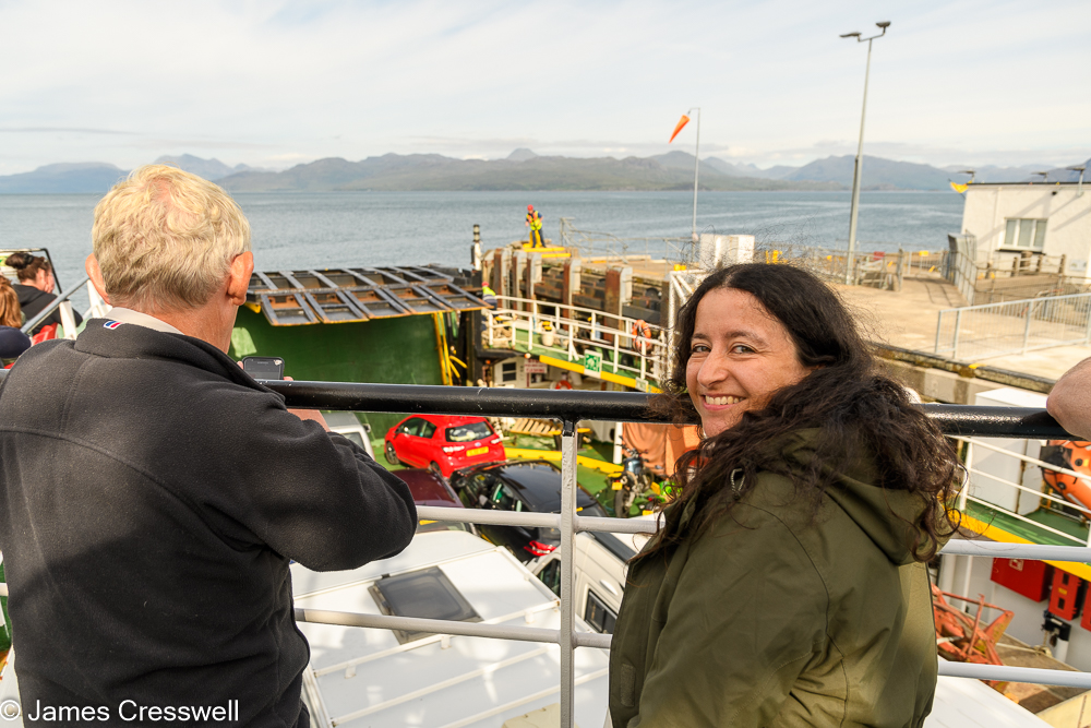 A man and a woman standing on a car ferry