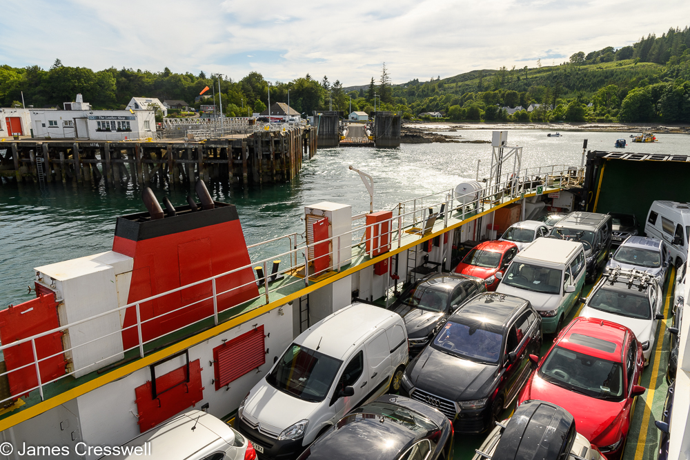 Looking down onto the deck of a ferry full of cars