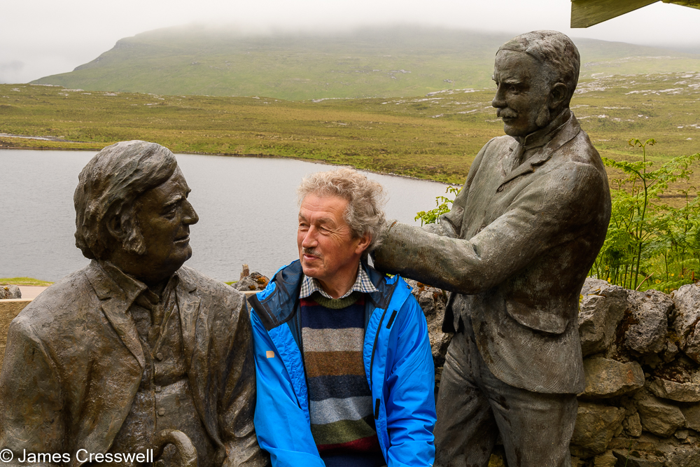 A man in-between two statues