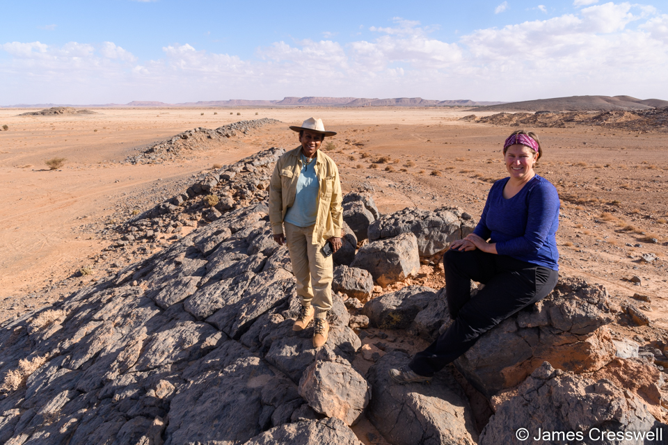 Sita and Caitlin standing on and outcrop of Silurian orthoceras limestone that has been cut by faulting.