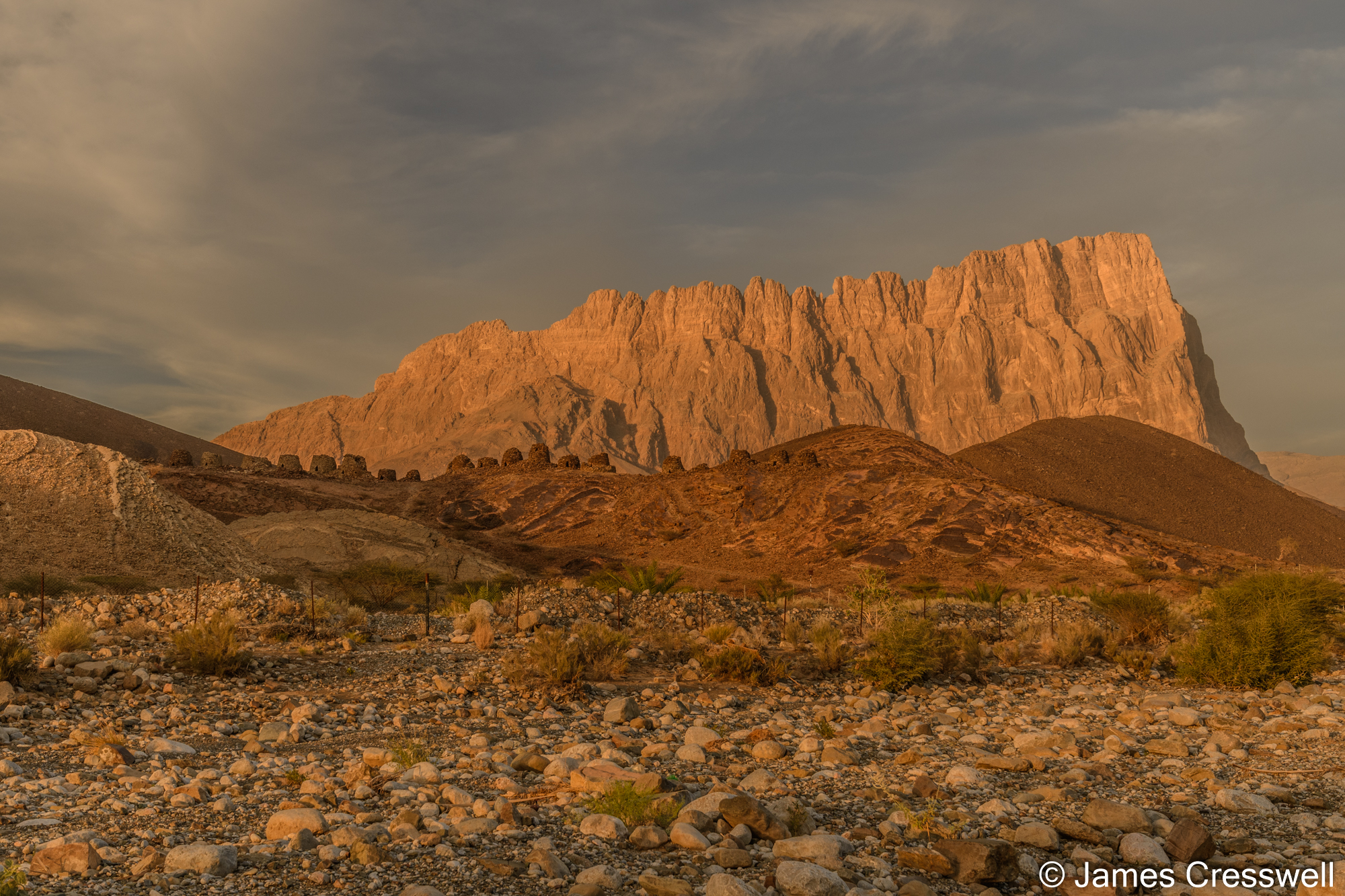 The Al Ayn Bronze Age tombs in front of Jebel Misht a Triassic aged atol, with a volcanic base and marble top.