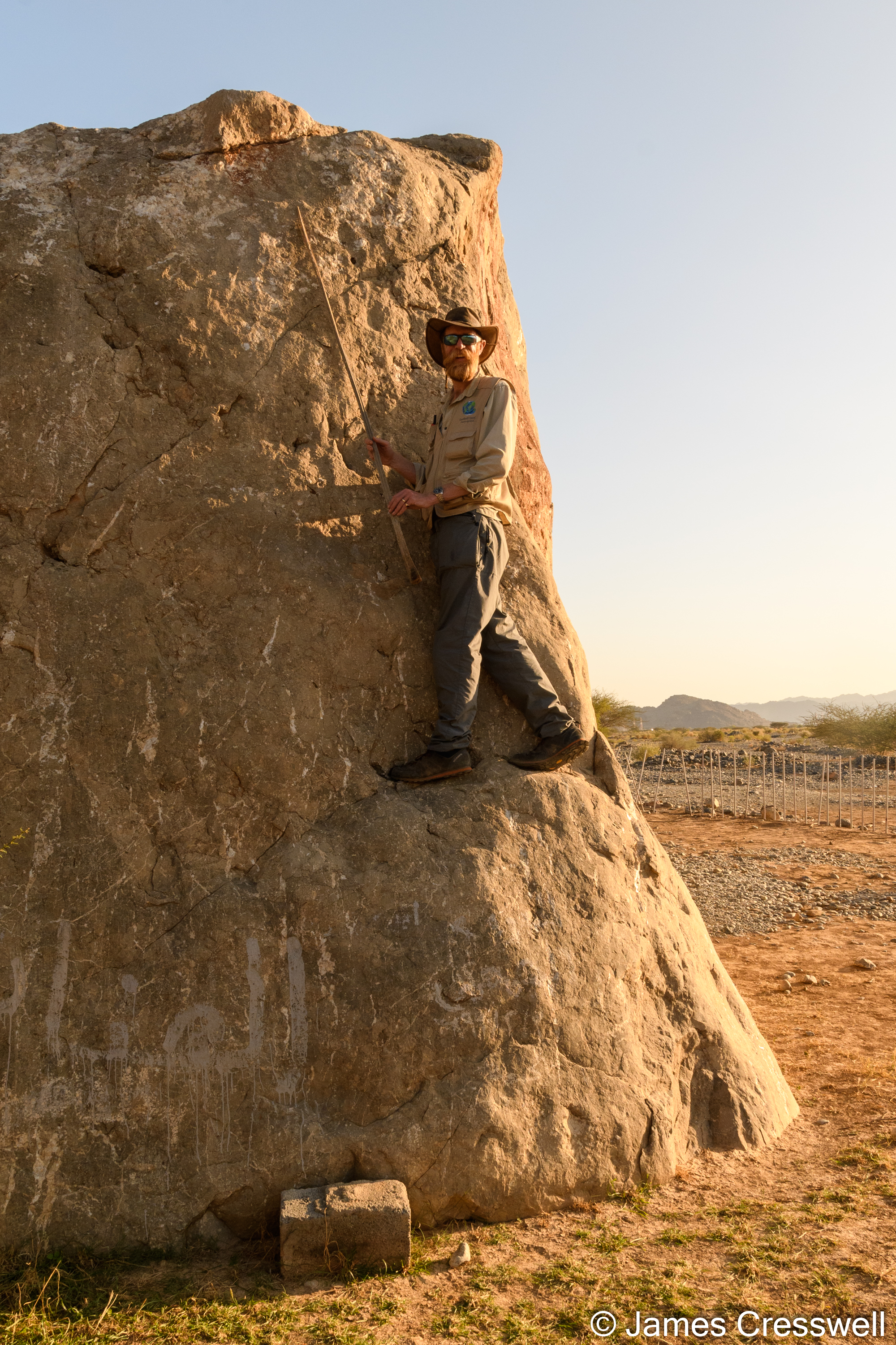 Man pointing to rock