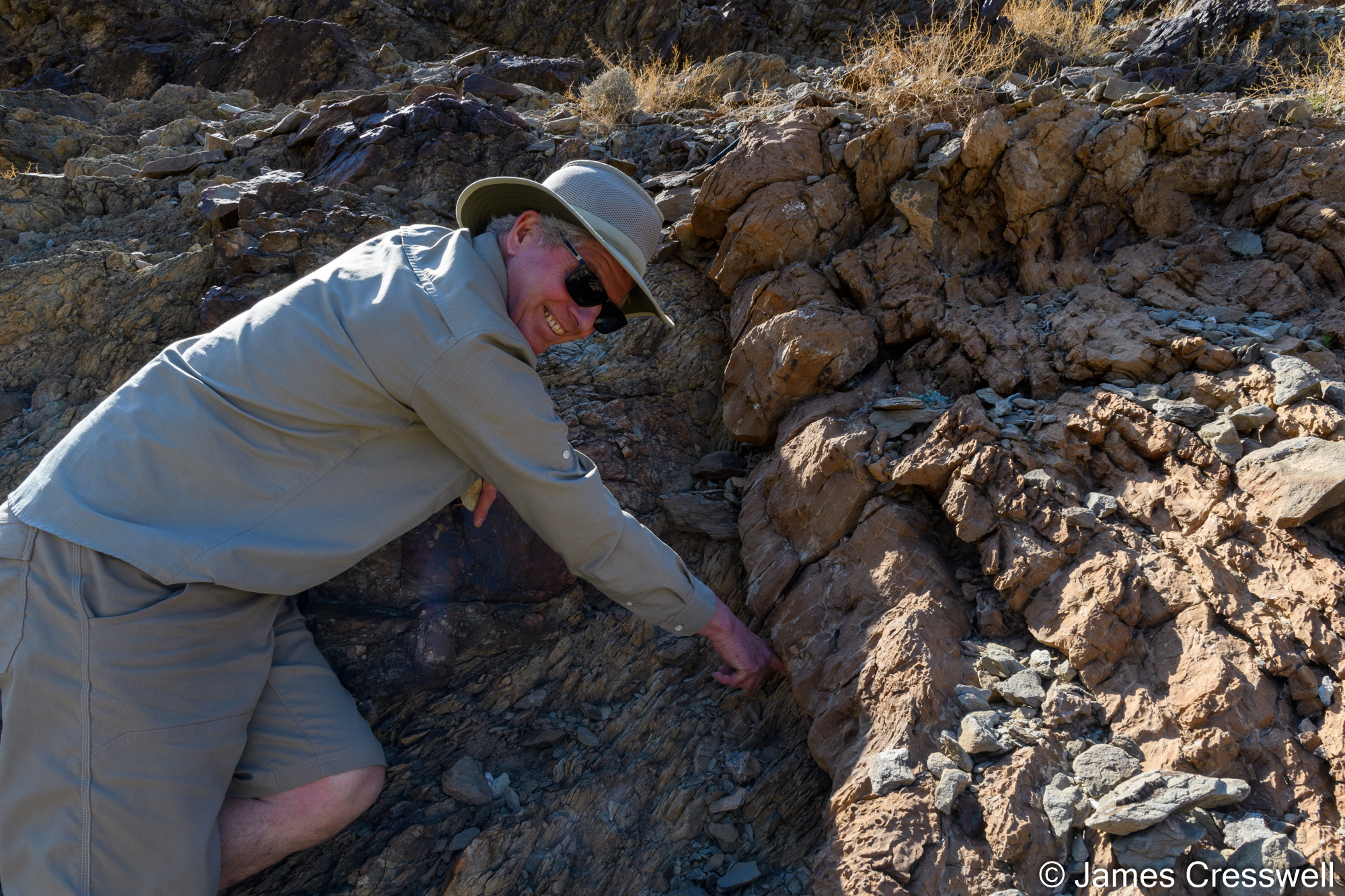 A man touching rock
