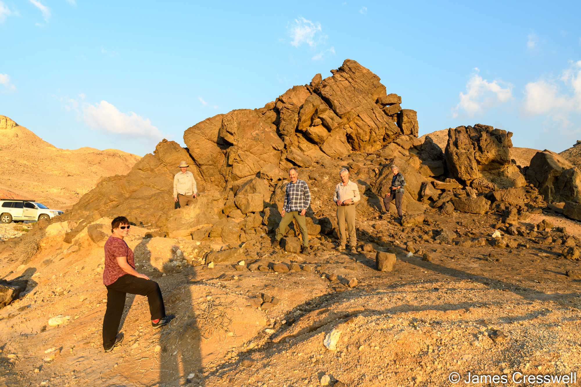 People standing in front of an outcrop of carbonatite