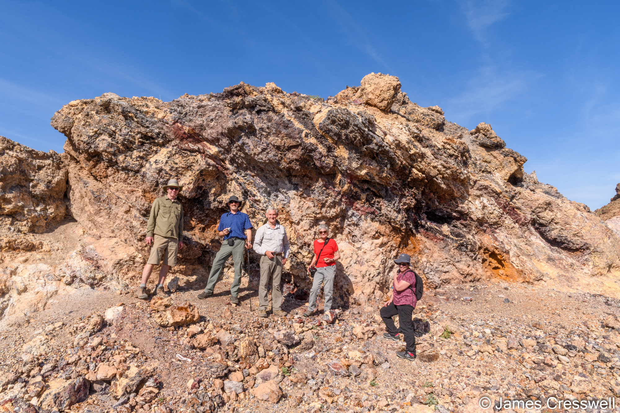 Group of people by a rock outcrop