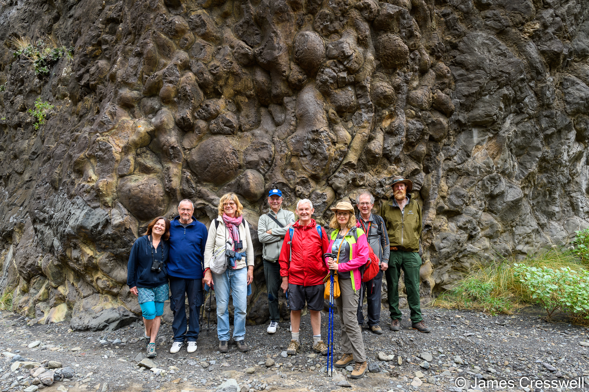A group in front of an outcrop of pillow basalts.