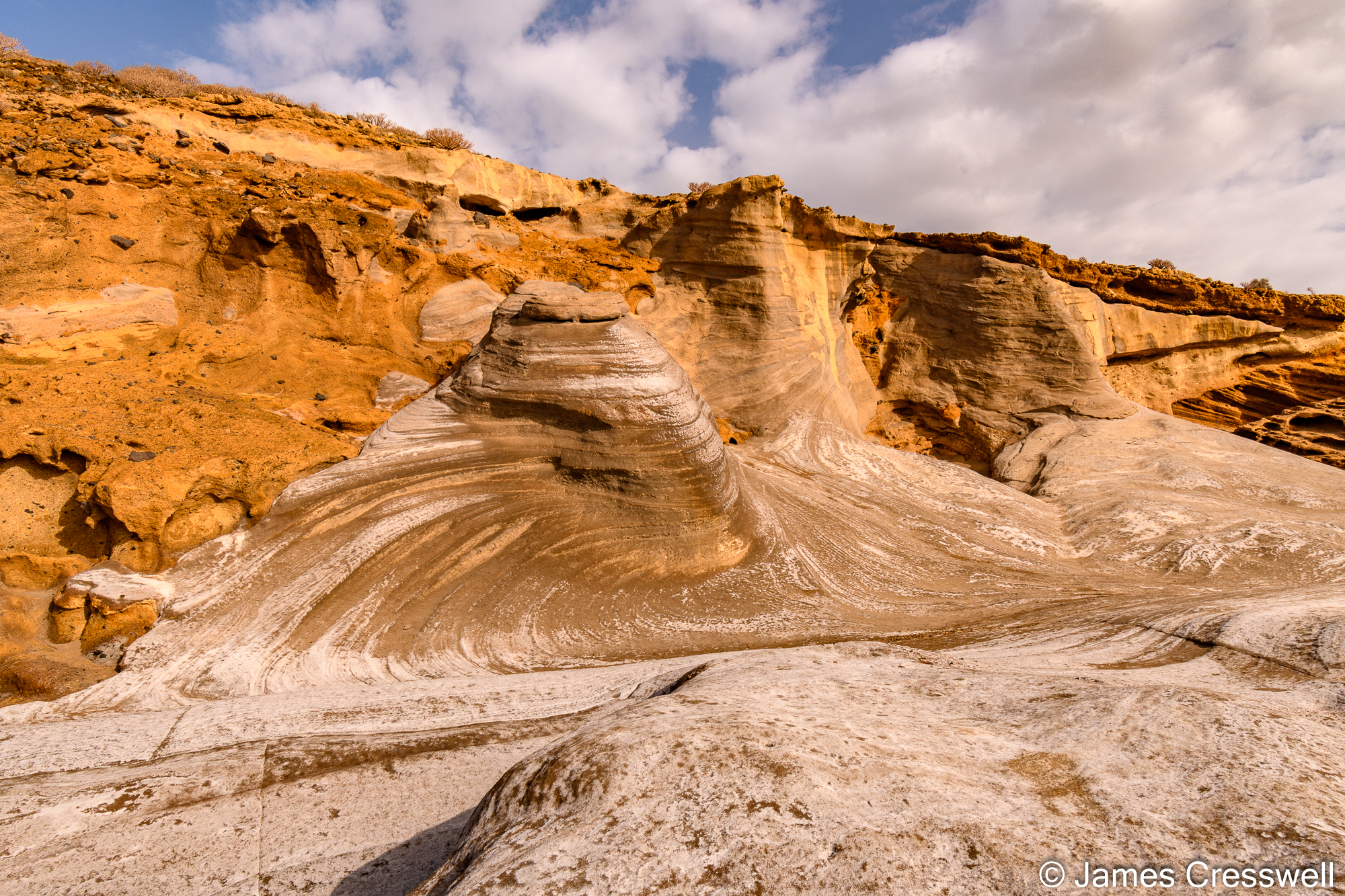 The fossilised beach dunes on the palagonite, the sea level has since fallen or the volcano has uplifted since they were deposited.