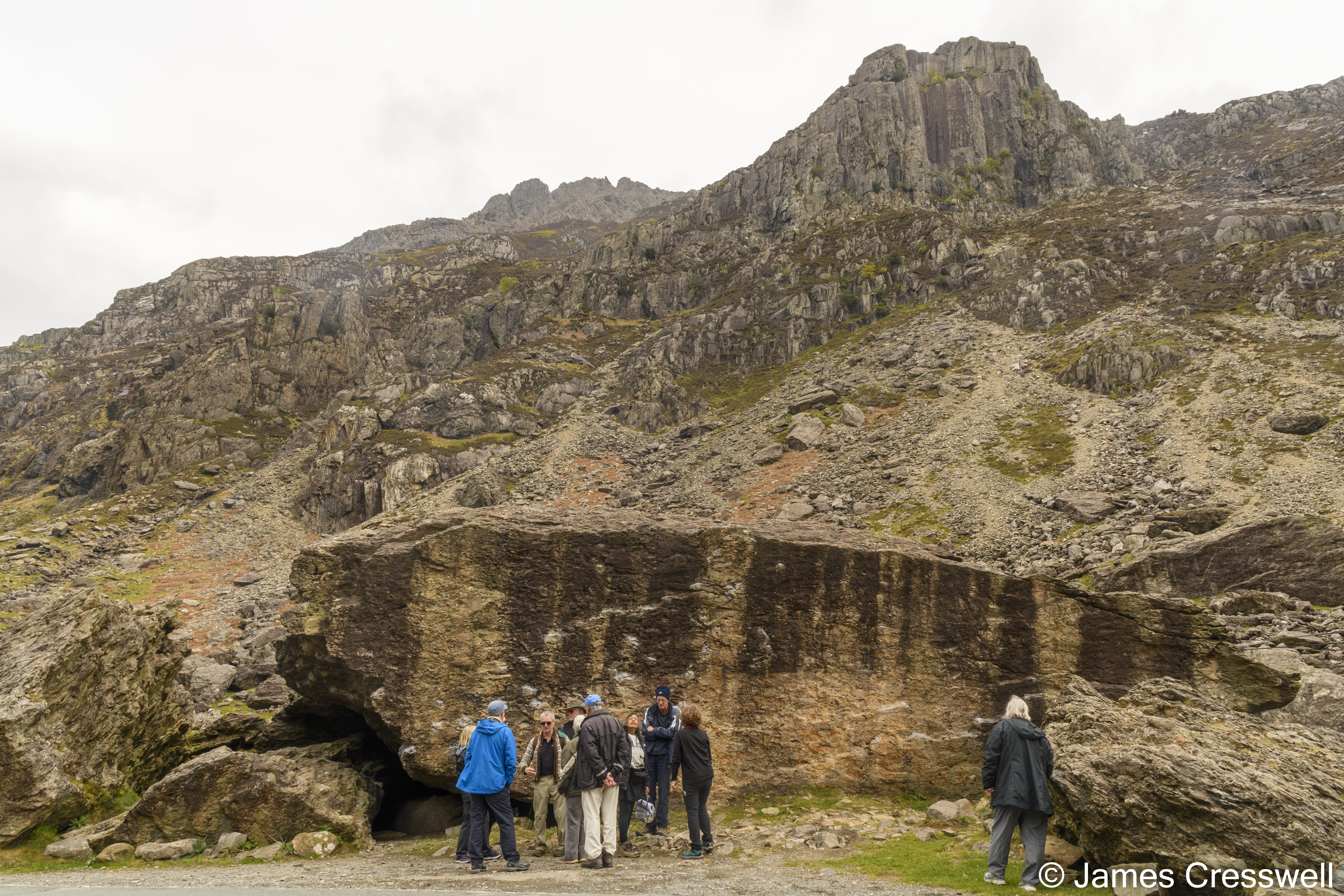A group of people by a rock face