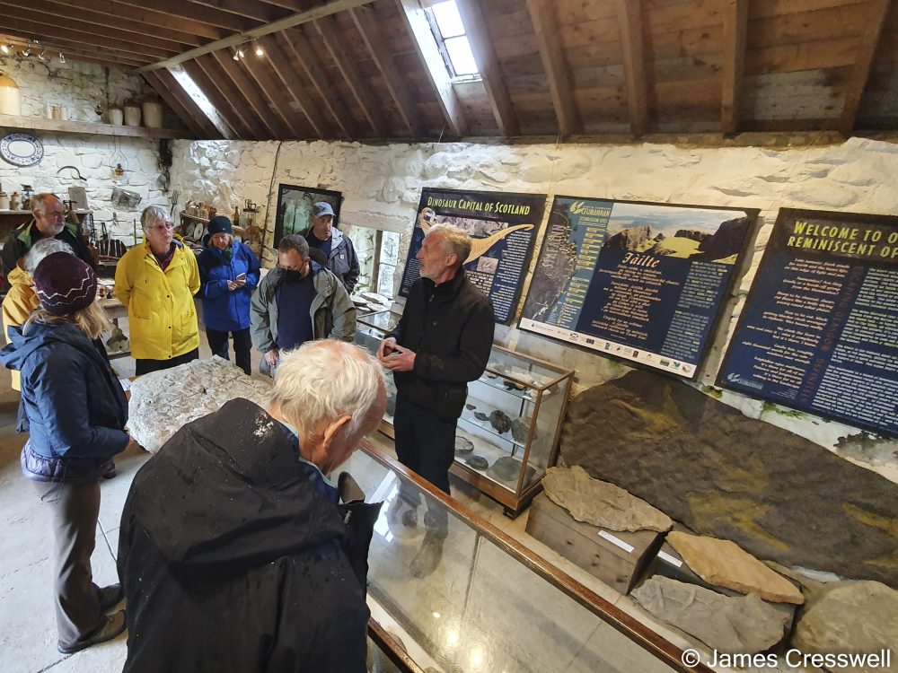 Man talking to a group of people in a museum