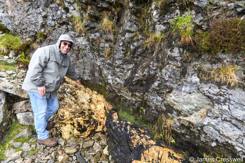 Man pointing to rock