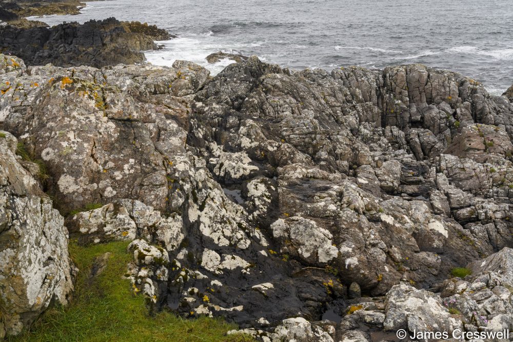 Rock with sea in background