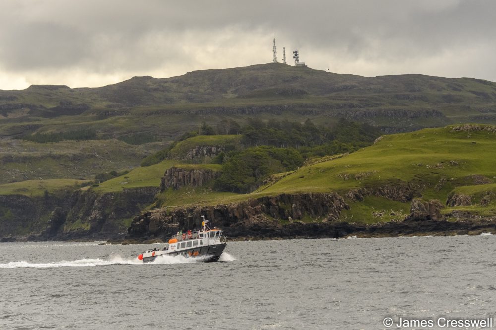 A boat on the sea with land in the background