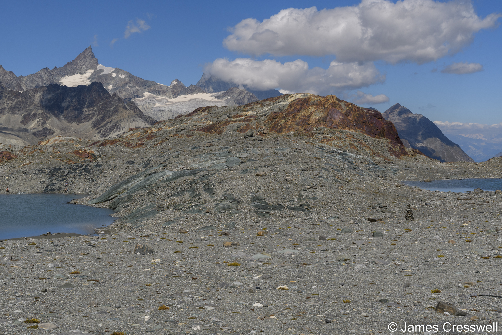 View of mountains with a rock formation in the foreground