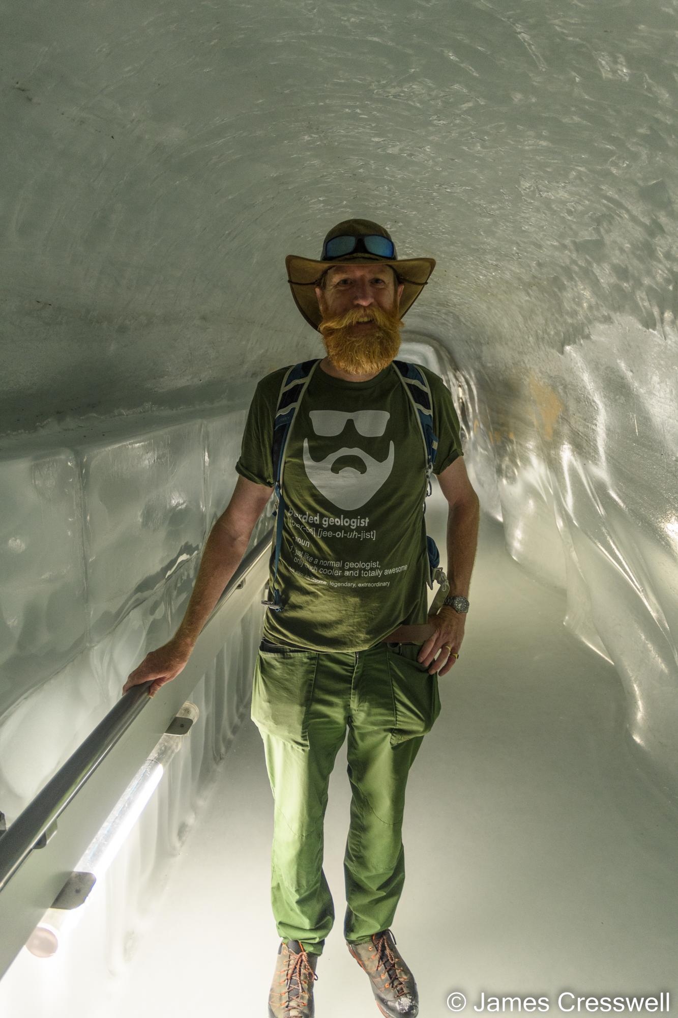 A man standing in a tunnel of ice