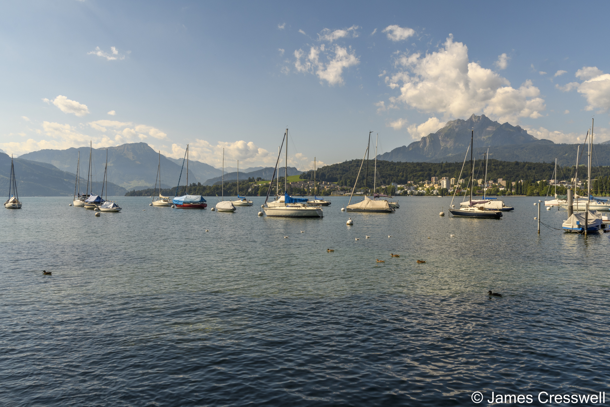Boats on a lake with mountains in the background