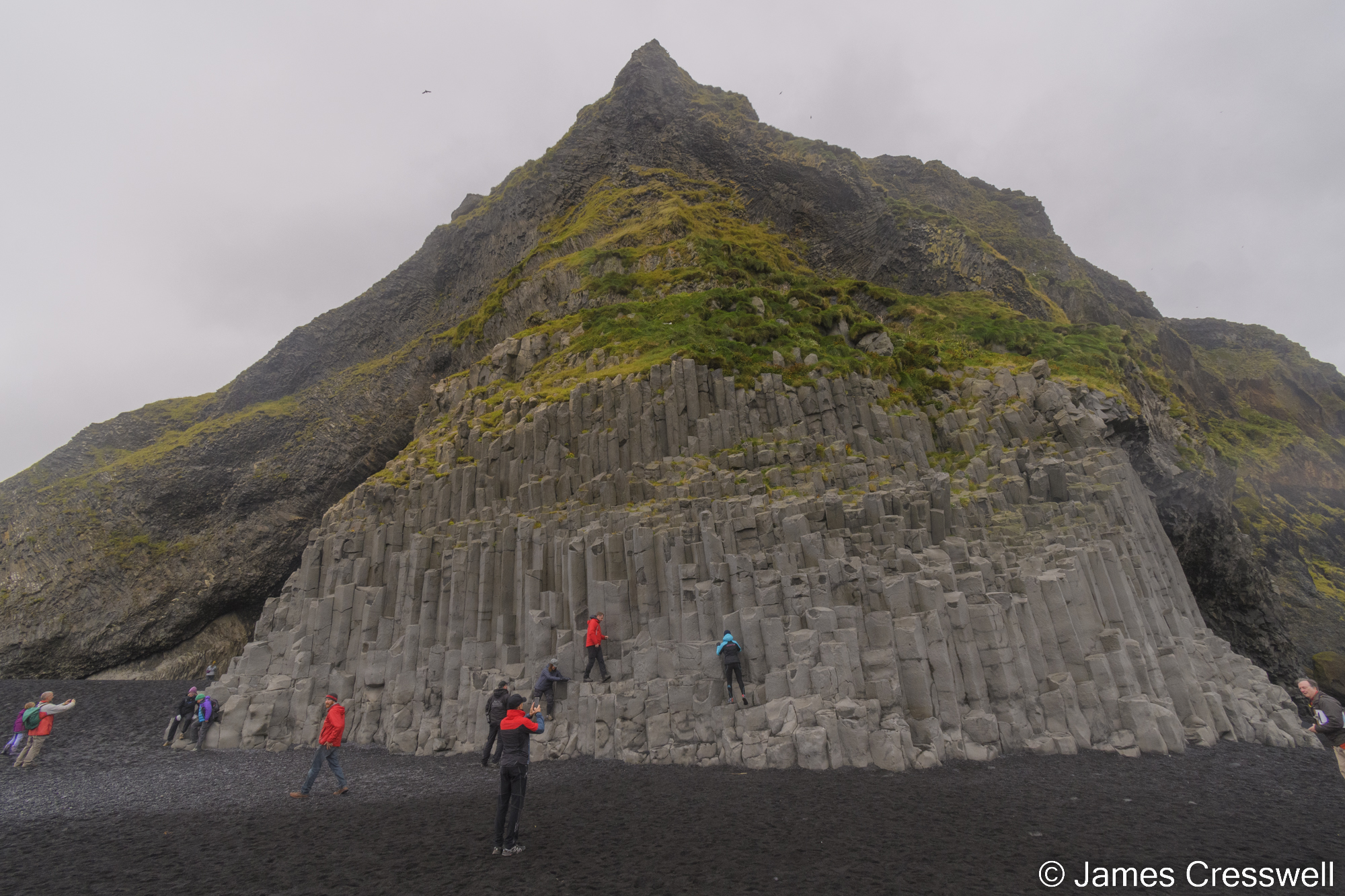 People climbing on rocks at a beach