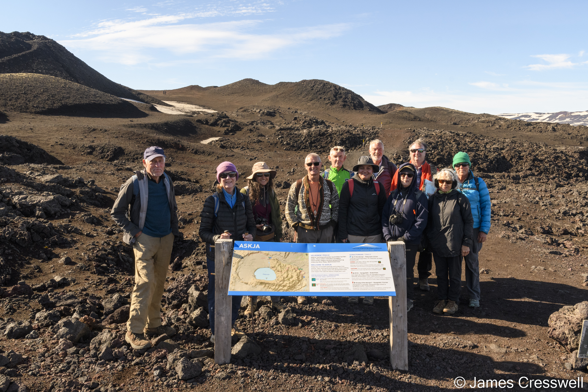 Group of people standing around an information sign board