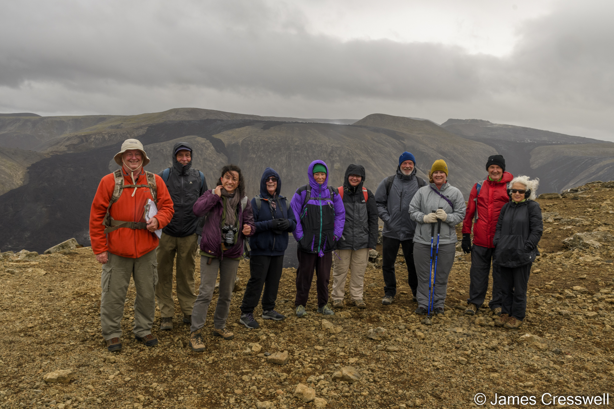 Group of people in front of volcanic landscape