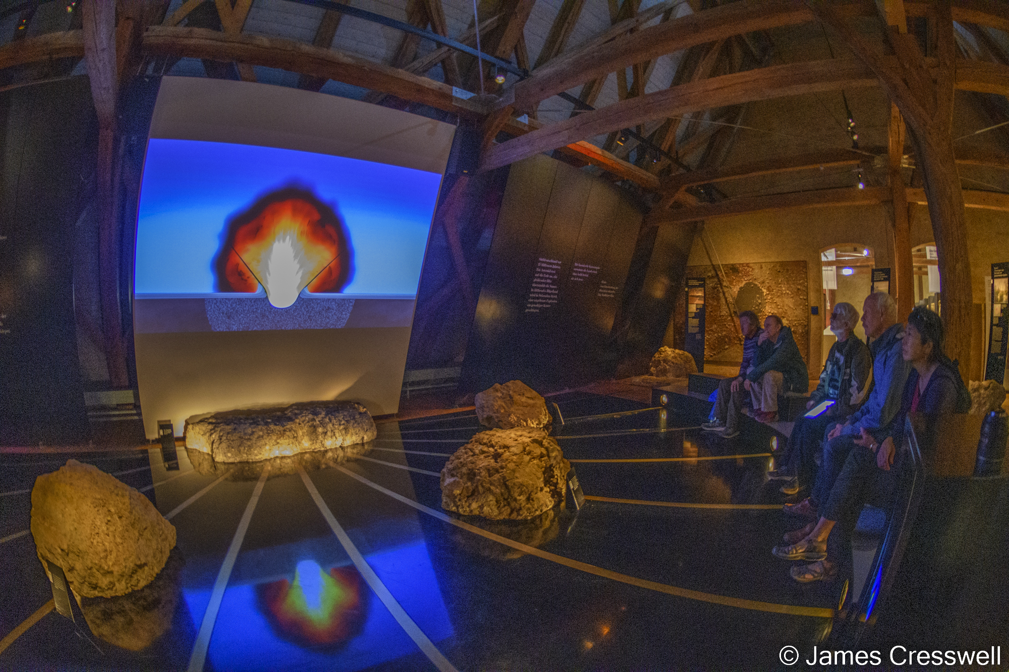 People watching a video in a museum
