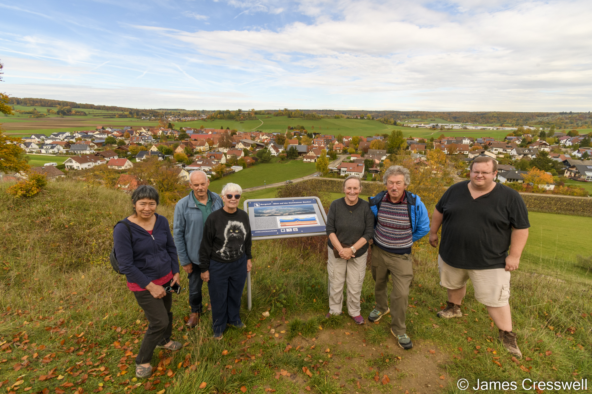 People standing in front of a village