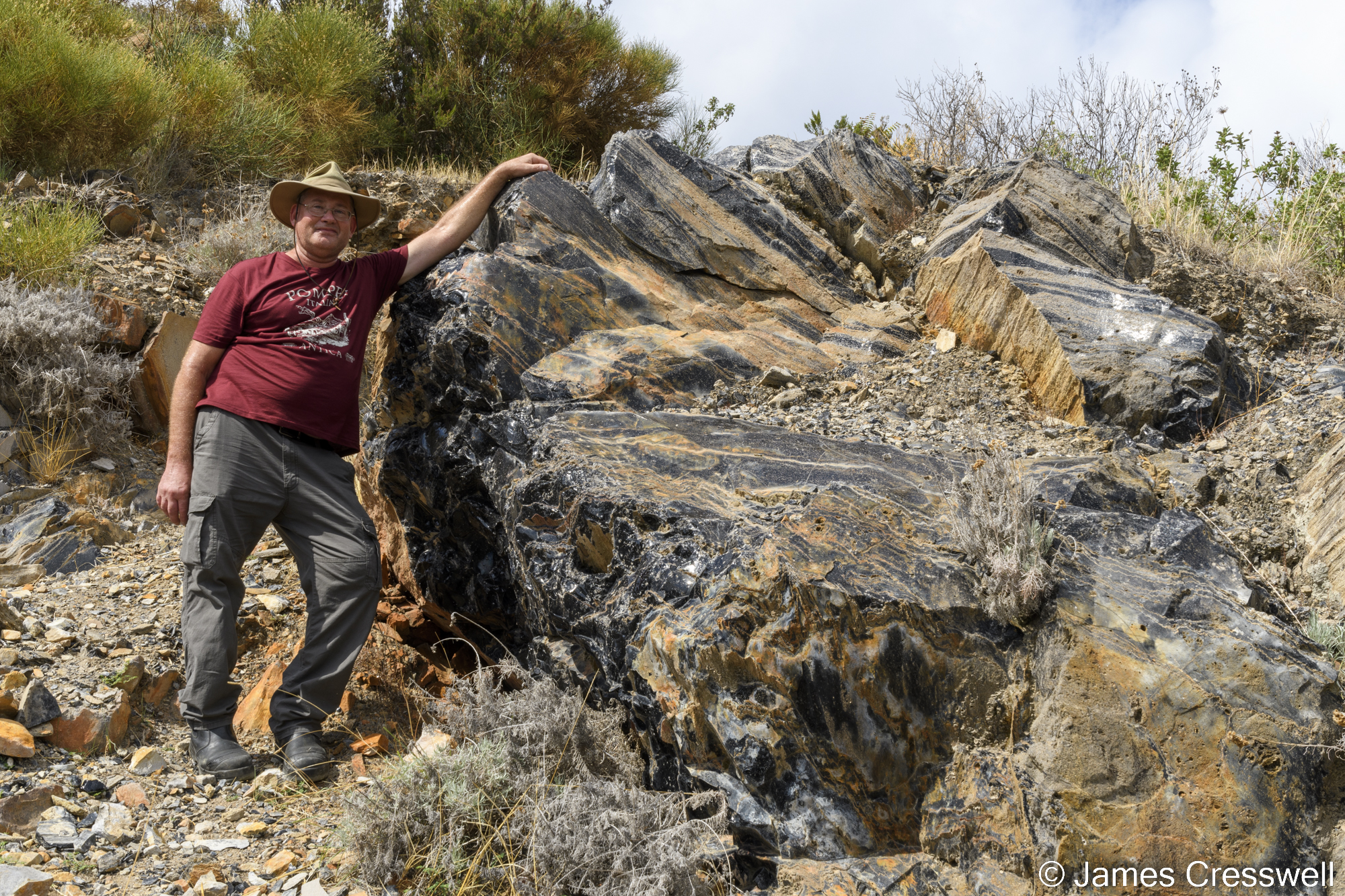 Man standing by a rock