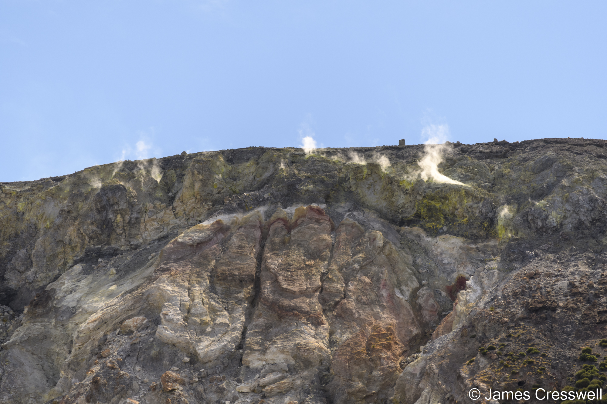 Steam rising from a volcanic surface