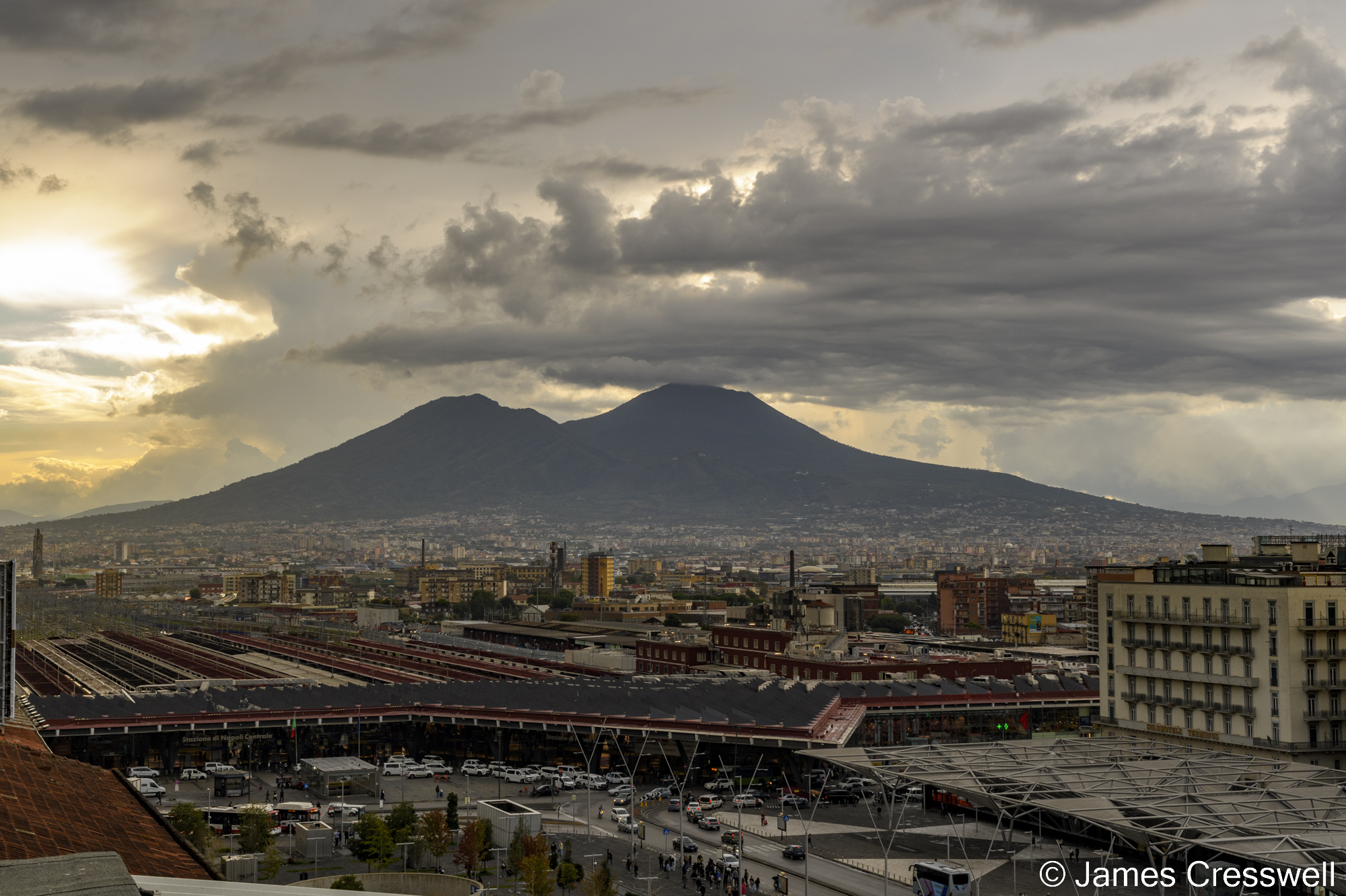 View of a volcano with a city in the foreground