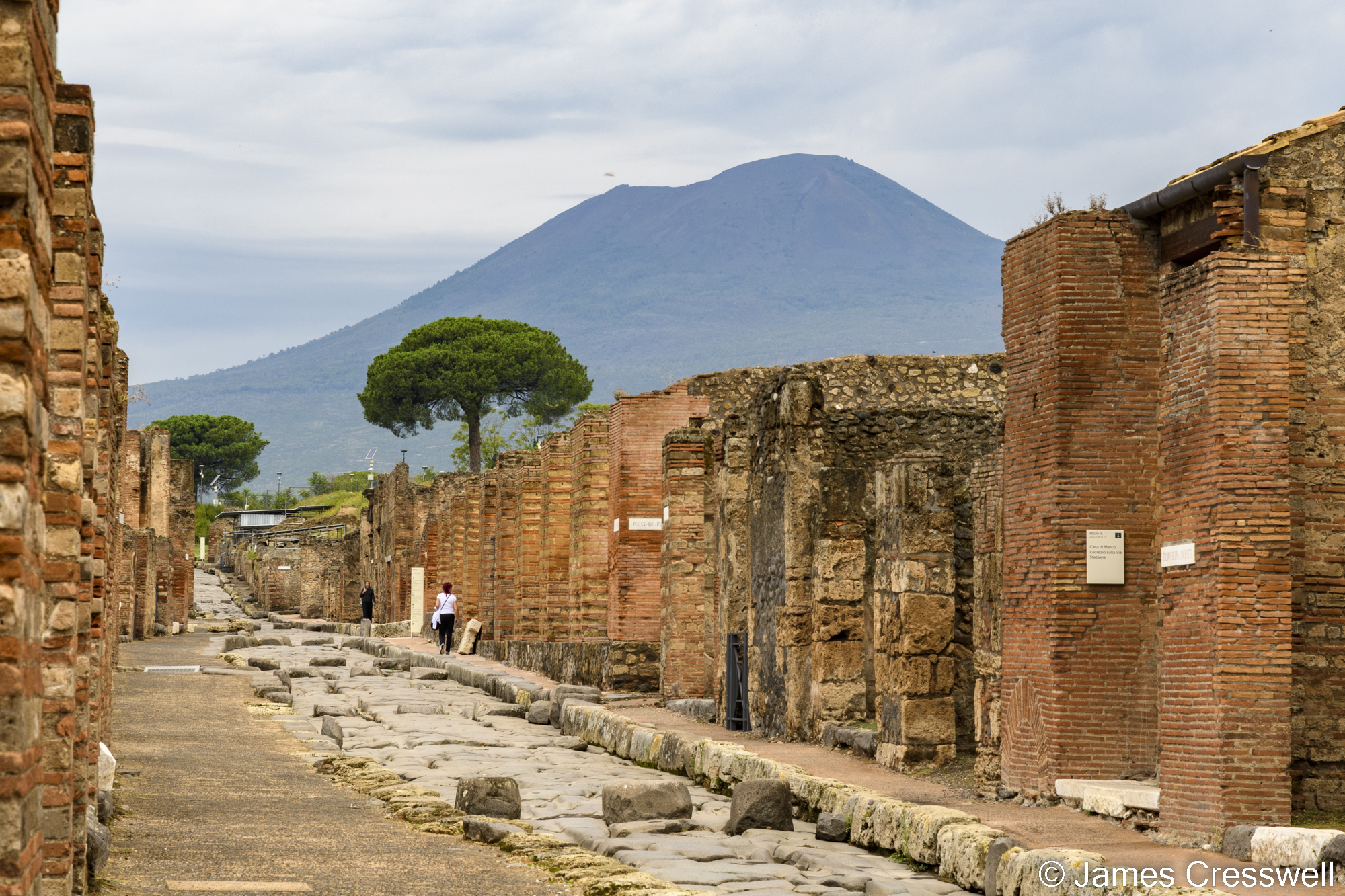 A volcano with a ruined city in the foreground