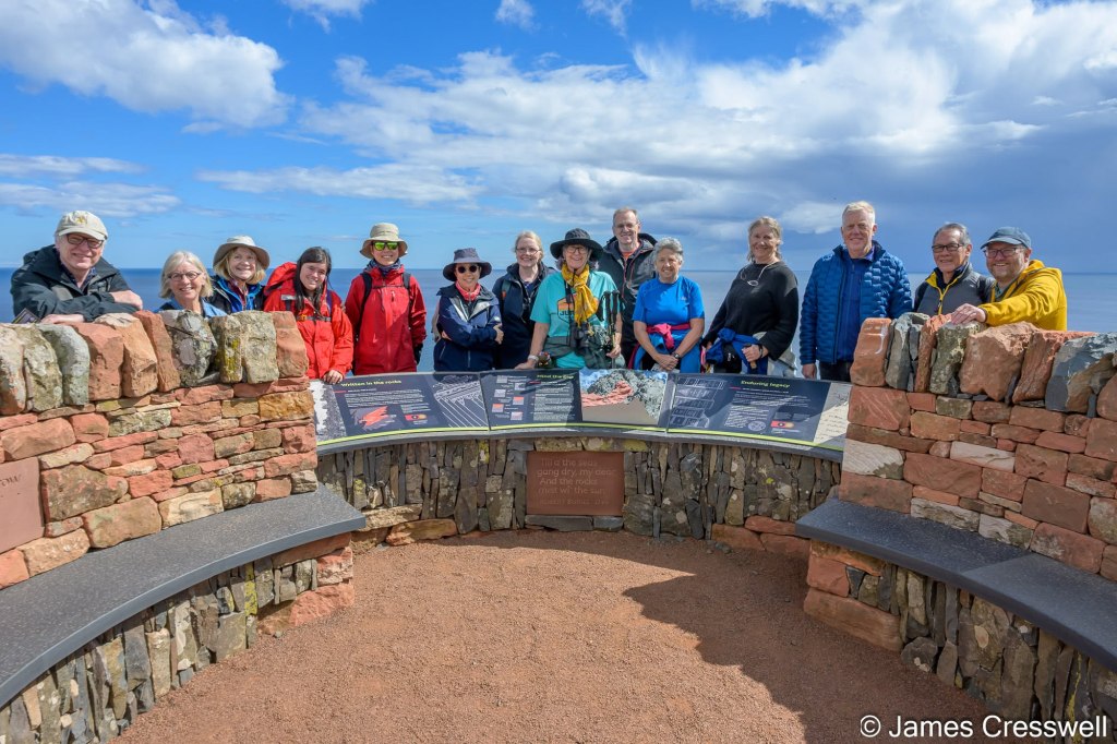 The GeoWorld Travel group with Angus Miller at the new Deep Time Trail viewpoint above Siccar Point.