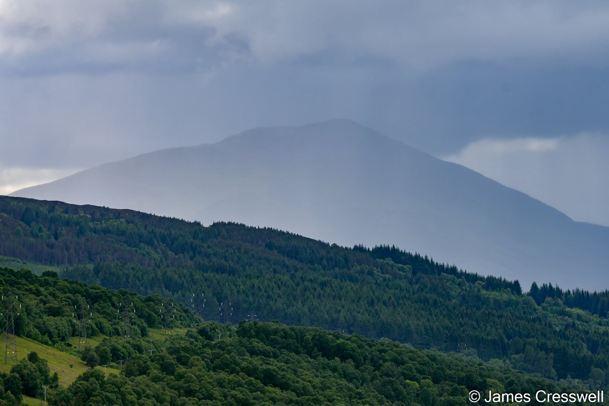 Schiehallion, viewed from Queen's View. This distinctive 1,083 m quartzite mountain was chosen by Astronomer Royal Nevil Maskelyne for his famous 1774 experiment to measure the mountain's gravitational attraction. 